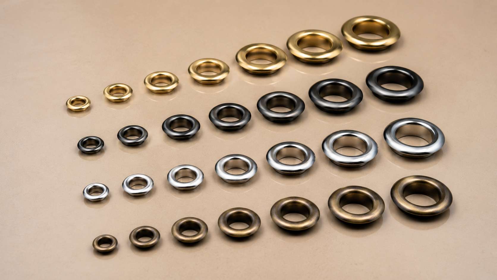what is a grommets, For the search query what is a grommets, the image shows multiple round metal grommets arranged by size and finish.